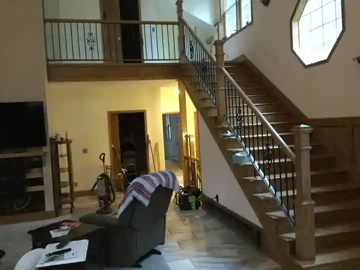 Grand foyer staircase with iron and wood railings