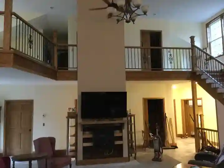 Two-story great room with custom iron loft railings