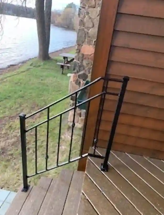 Black iron deck railing with lake view