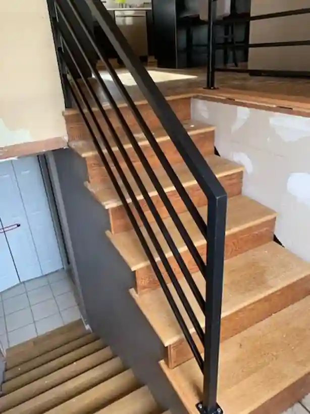 Modern black iron stair railing with wood treads