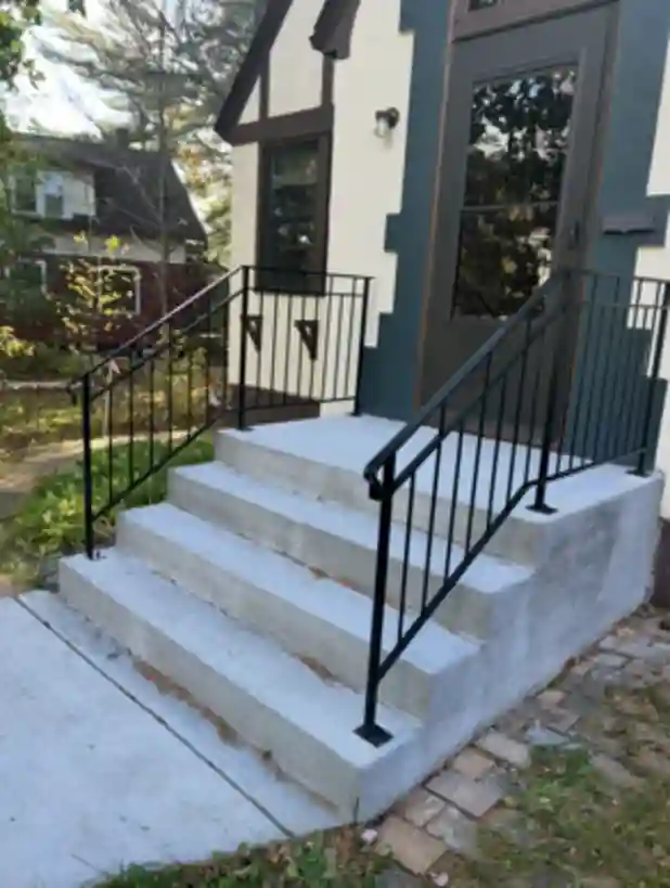 Custom iron railings with scroll details on Tudor entry steps